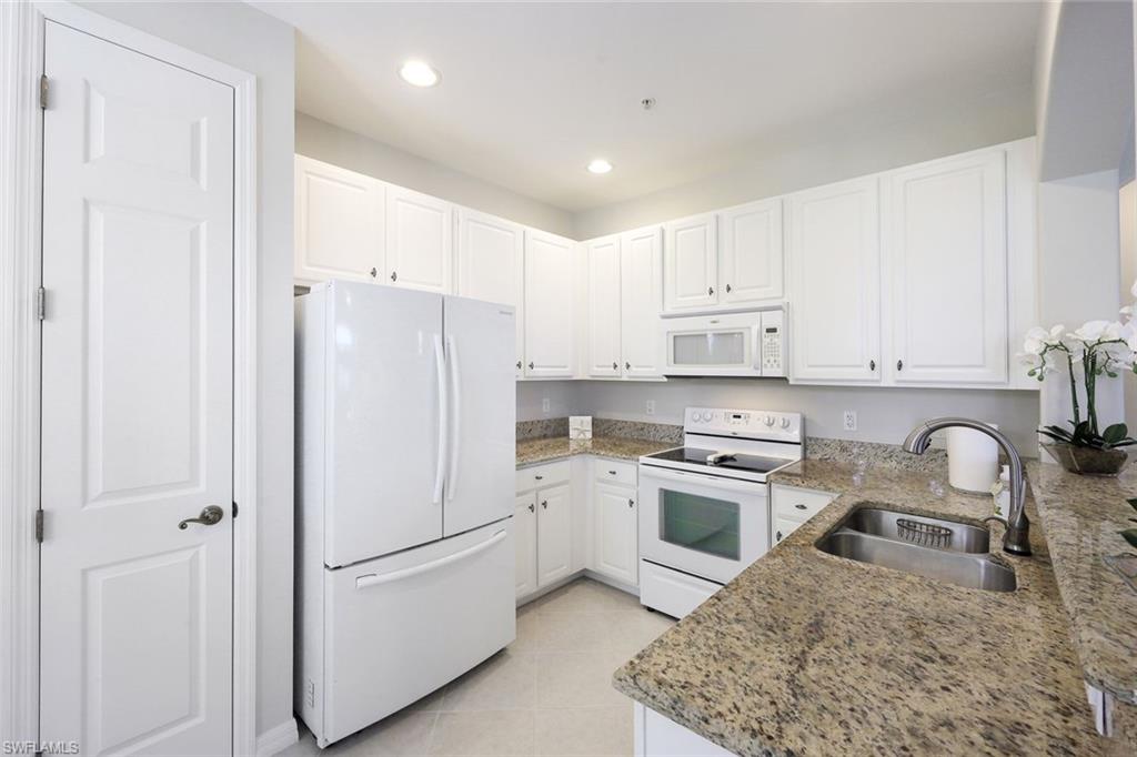 1423 Santiago Circle, Unit 1702 Naples, FL 34113 - Photo 11 of 46 a kitchen with a sink stove and refrigerator