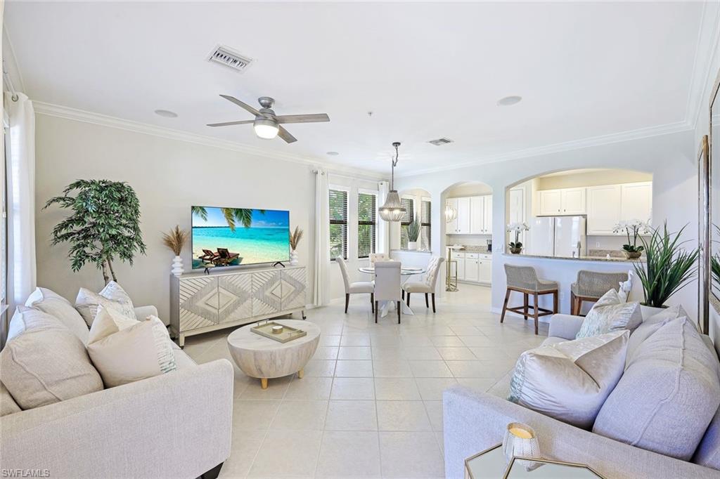 1423 Santiago Circle, Unit 1702 Naples, FL 34113 - Photo 4 of 46 a living room with furniture potted plant and a large window