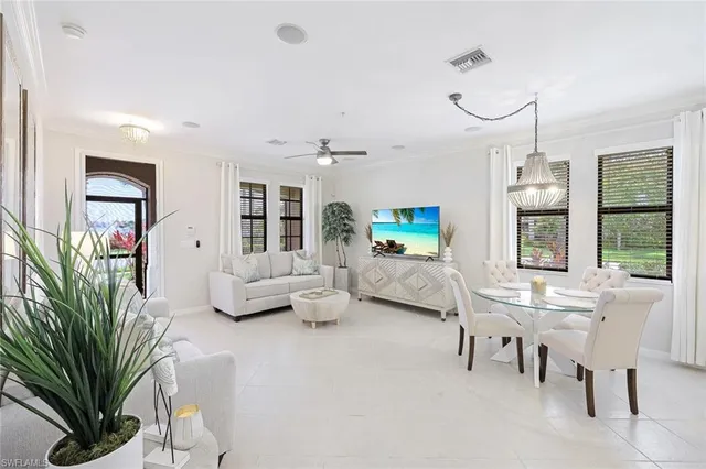 a living room with furniture fireplace and a large window
