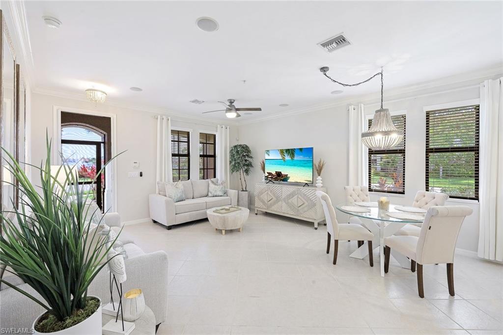 1423 Santiago Circle, Unit 1702 Naples, FL 34113 - Photo 5 of 46 a living room with furniture fireplace and a large window