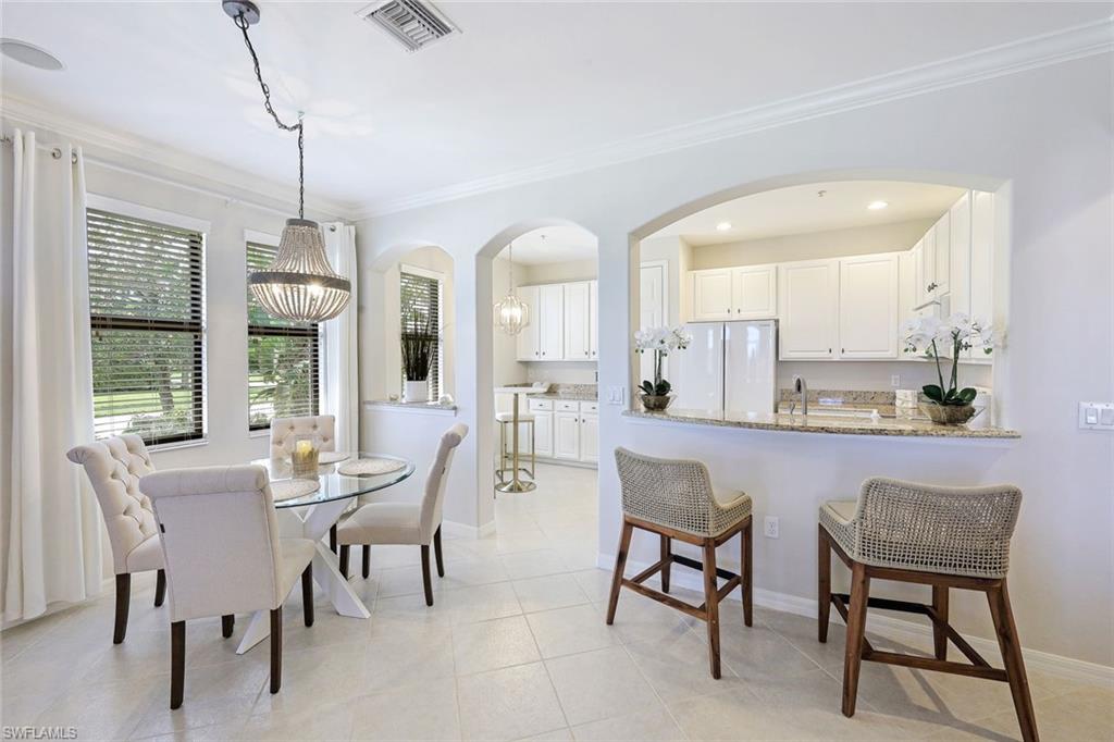 1423 Santiago Circle, Unit 1702 Naples, FL 34113 - Photo 8 of 46 a dining room with furniture a chandelier and window