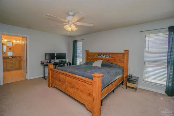 a living room with furniture flat screen tv and a chandelier