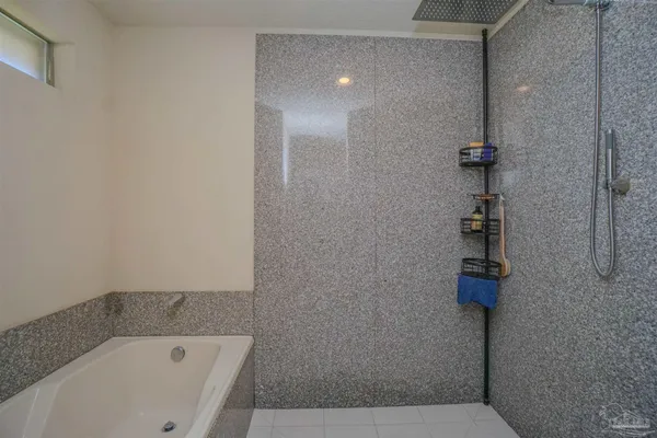 a bathroom with a bathtub and shower