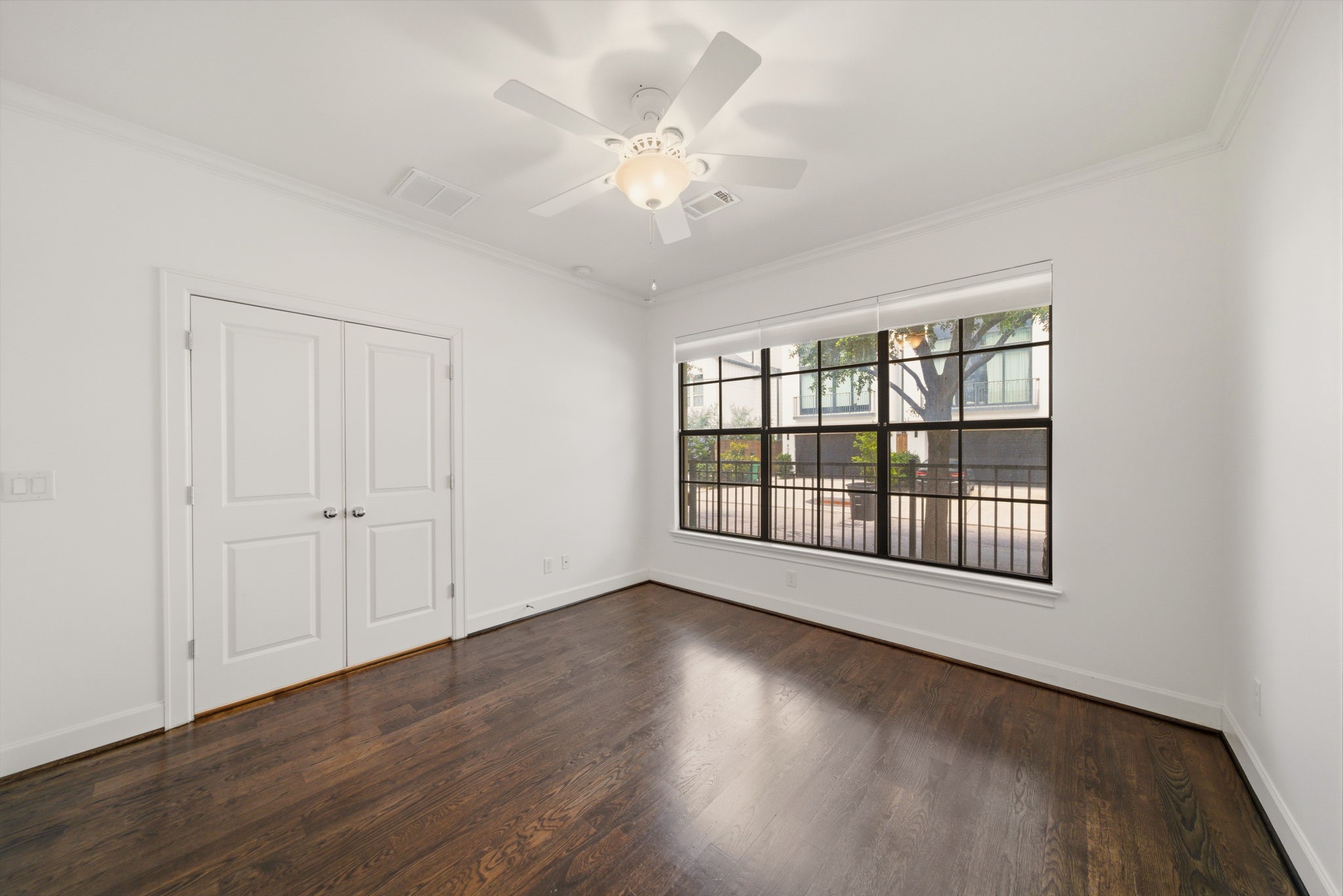 911 West Drew Street Houston, TX 77006 - Photo 27 of 44 a view of an empty room with a window and wooden floor