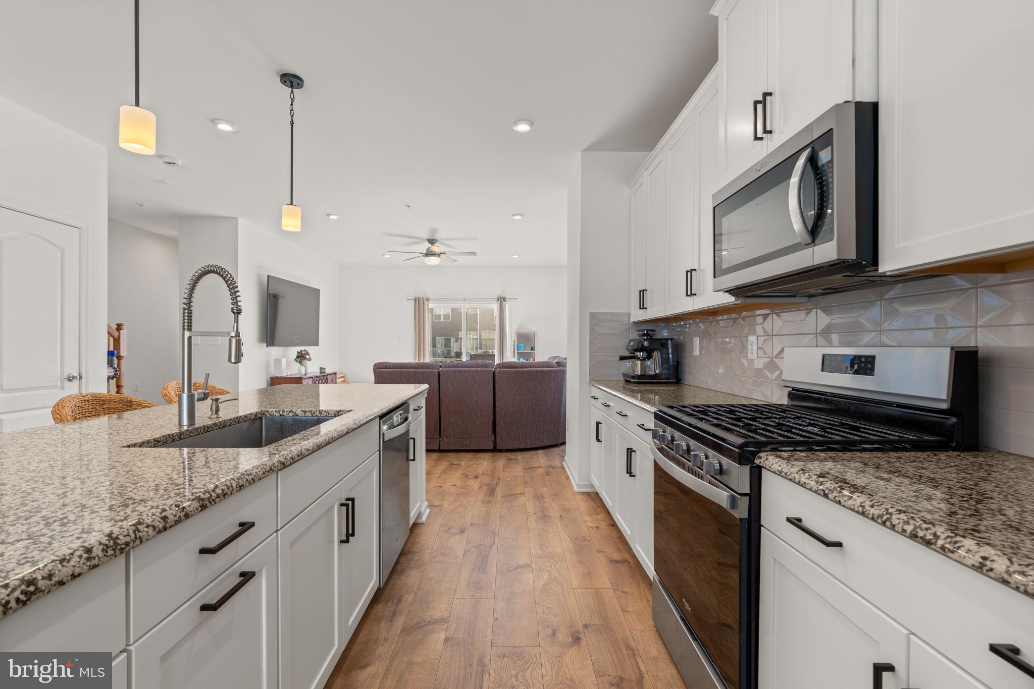 1605 Aster Lane Hanover, MD 21076 - Photo 13 of 44 a kitchen with granite countertop stainless steel appliances a sink a stove top oven a counter space and cabinets