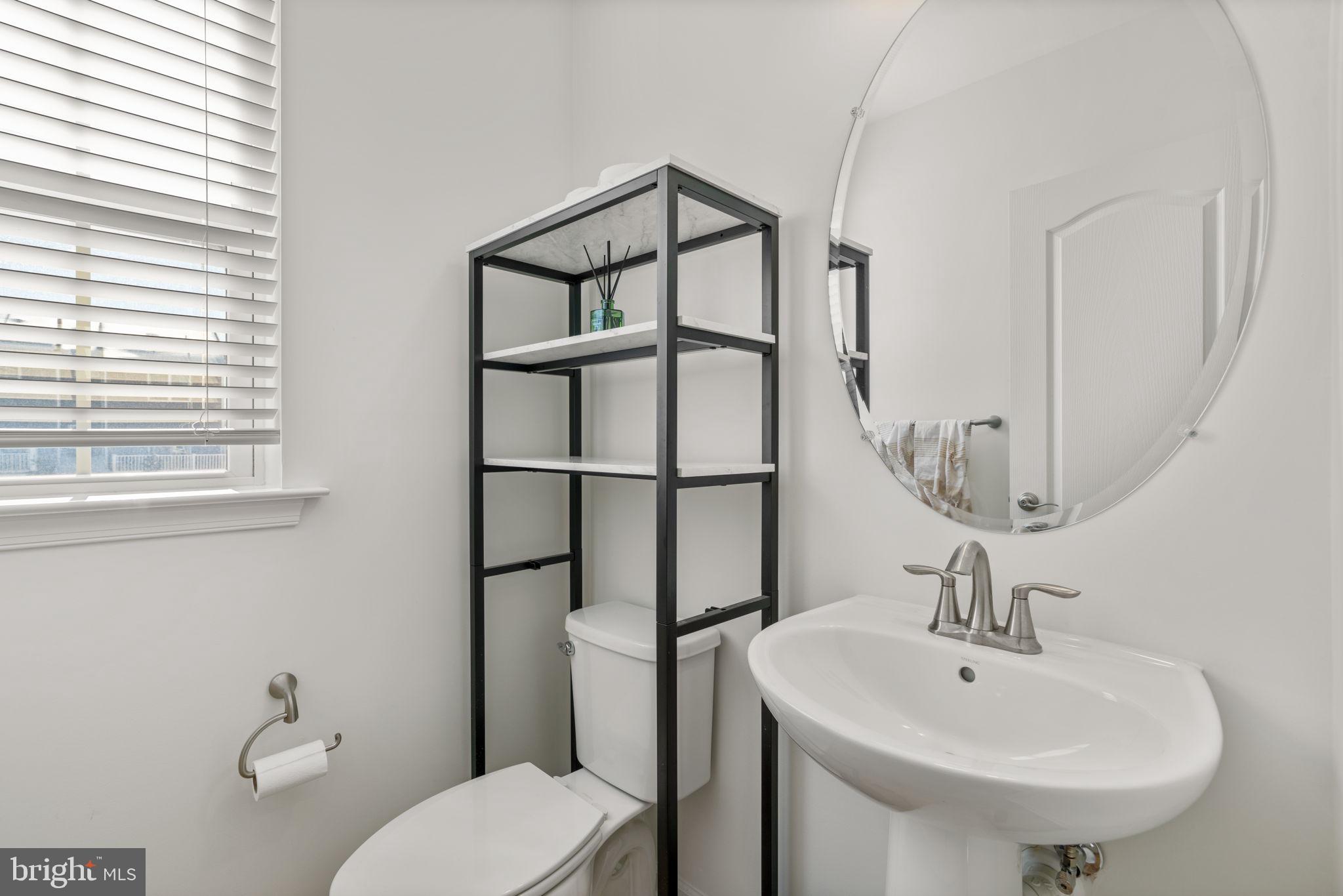 1605 Aster Lane Hanover, MD 21076 - Photo 19 of 44 a bathroom with a sink toilet and mirror