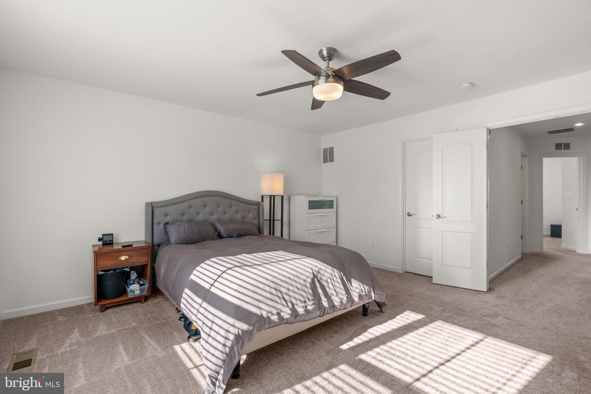 1605 Aster Lane Hanover, MD 21076 - Photo 22 of 44 a bedroom with a bed and a chandelier