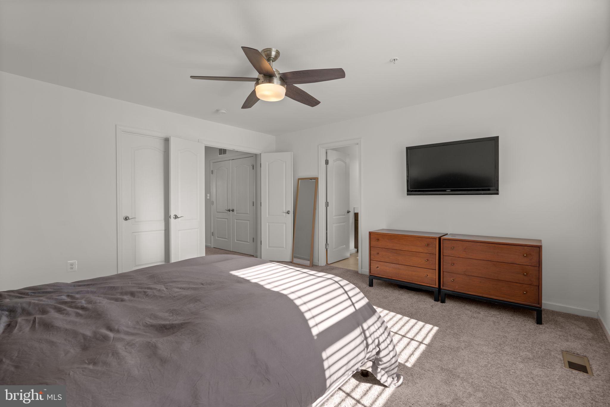 1605 Aster Lane Hanover, MD 21076 - Photo 23 of 44 a bedroom with a bed and a flat screen tv