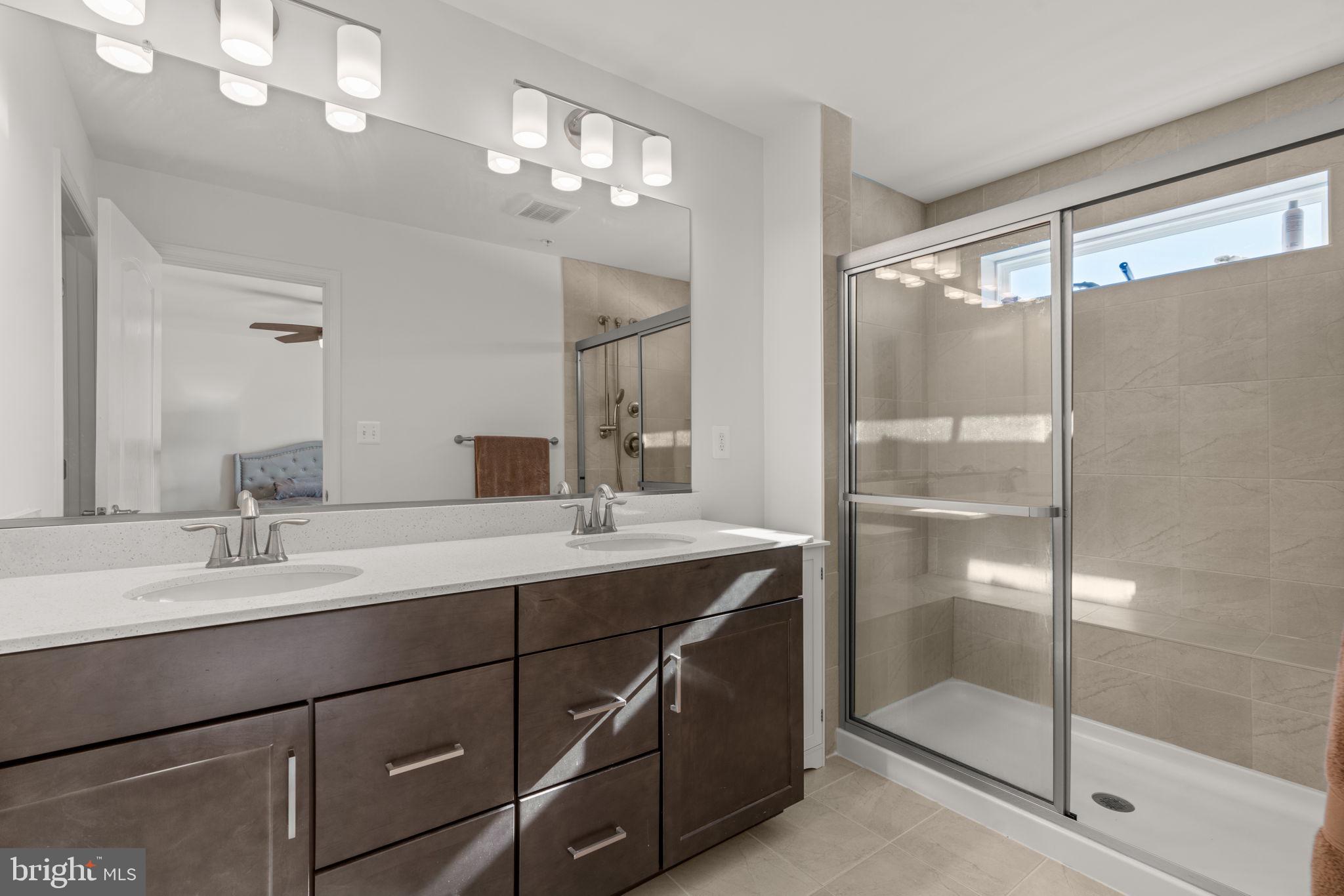 1605 Aster Lane Hanover, MD 21076 - Photo 24 of 44 a bathroom with a double vanity sink mirror and shower