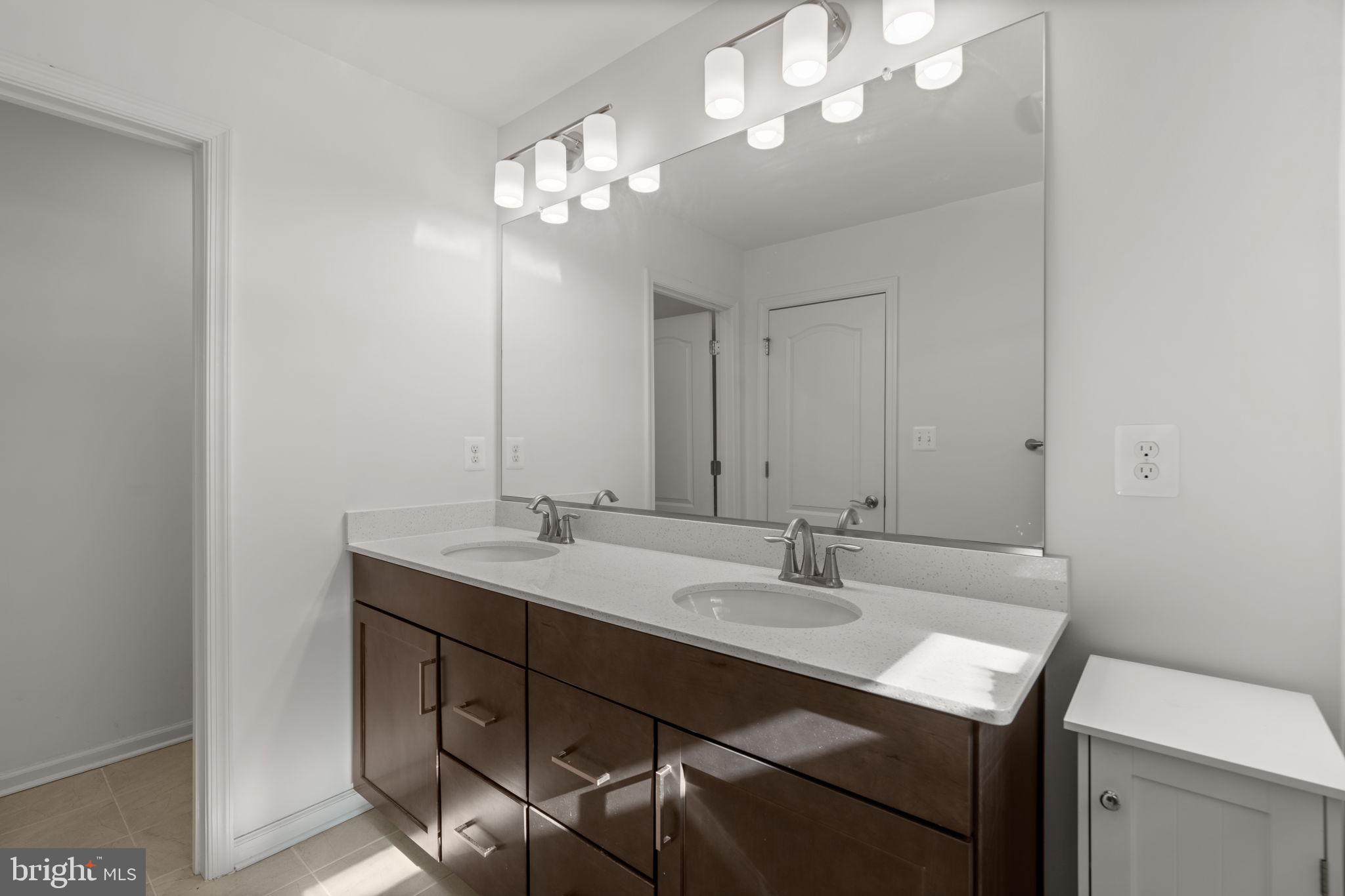 1605 Aster Lane Hanover, MD 21076 - Photo 26 of 44 a bathroom with a sink a light fixture and a mirror