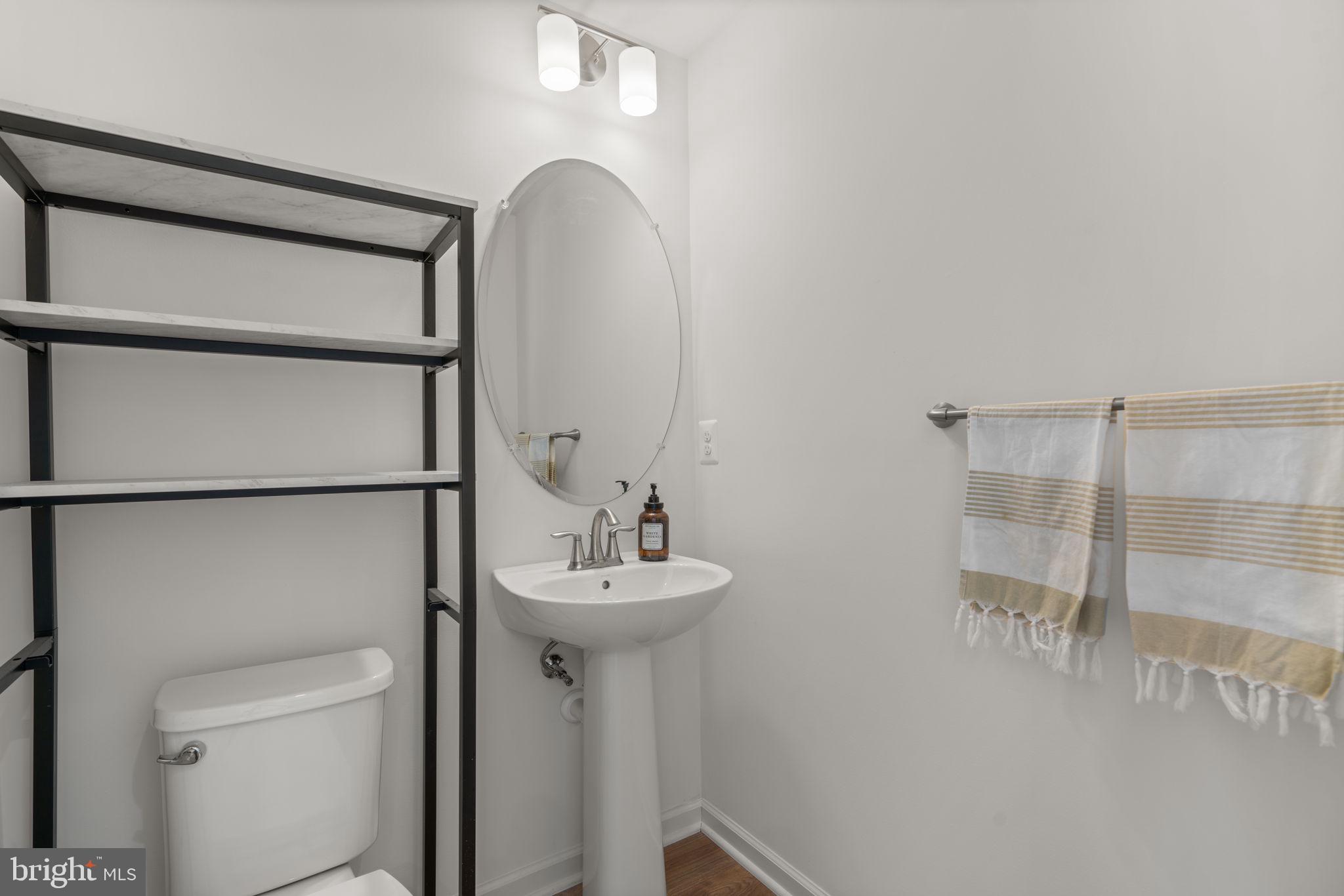 1605 Aster Lane Hanover, MD 21076 - Photo 37 of 44 a bathroom with a sink and mirror