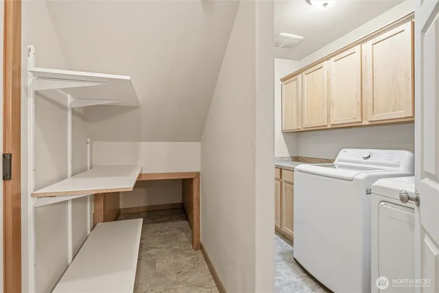 a view of washer and dryer with kitchen in the background
