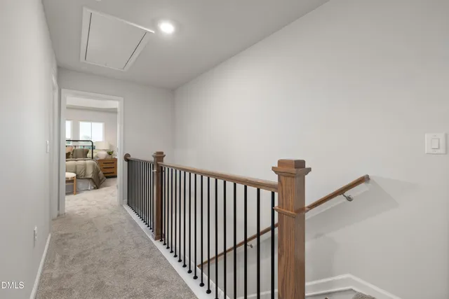 a view of a hallway to a livingroom and a way to rooms