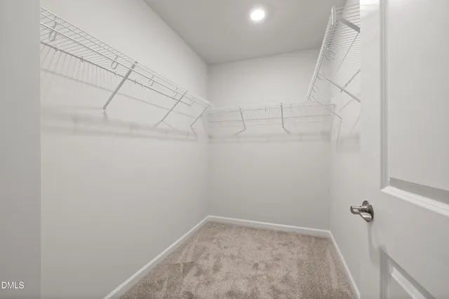 a spacious bedroom with a bed and window