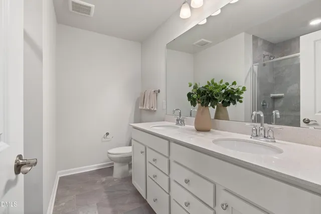 a bathroom with a granite countertop sink mirror and shower