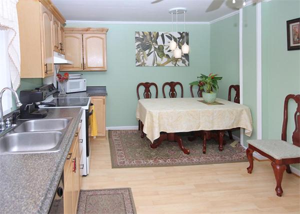 26 Granger Street Springfield, MA 01119 - Photo 6 of 18 a view of a kitchen with kitchen island a dining table and chairs