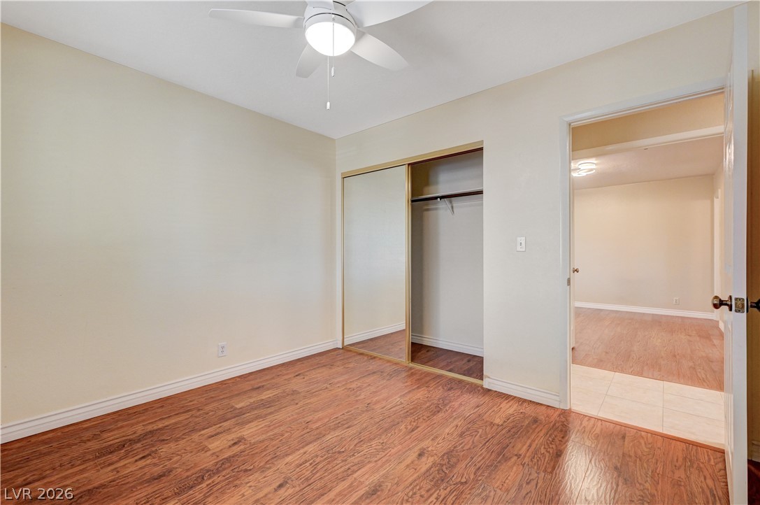 7631 Bermuda Road Las Vegas, NV 89123 - Photo 24 of 64 A quiet bedroom showcases wood flooring and a convenient mirrored closet.