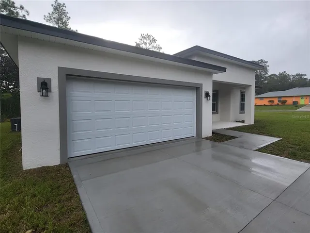 a view of an house with backyard space and garden
