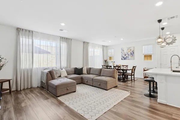 a living room with furniture and wooden floor