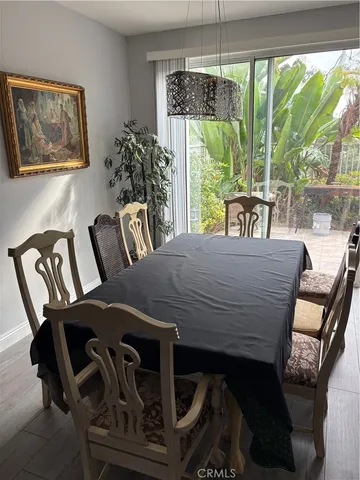 a view of a dining room with furniture large windows and wooden floor