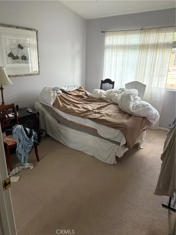 a spacious bedroom with a bed and a couch