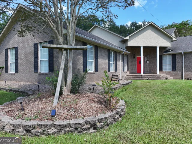 a front view of a house with garden