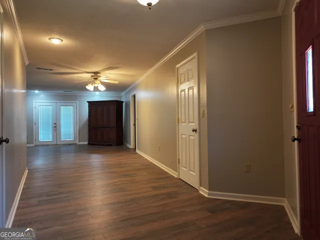 a view of an empty room with wooden floor