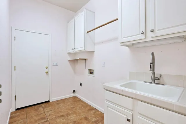 a view of livingroom with furniture wooden floor windows and chandelier