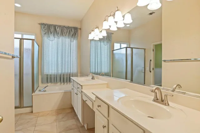 a bathroom with a sink vanity and a mirror