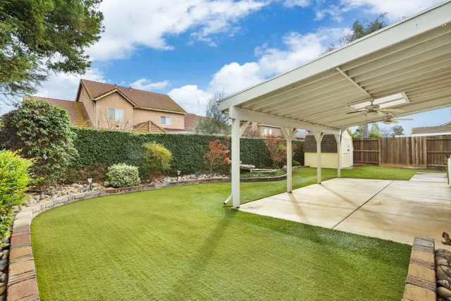 a view of a house with backyard and porch