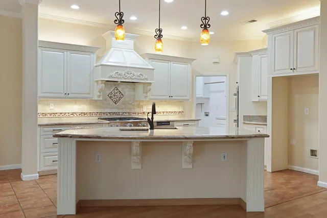 a kitchen with stainless steel appliances granite countertop a sink and a stove