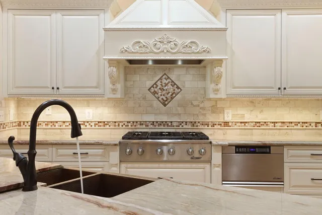a kitchen with granite countertop a stove and a sink