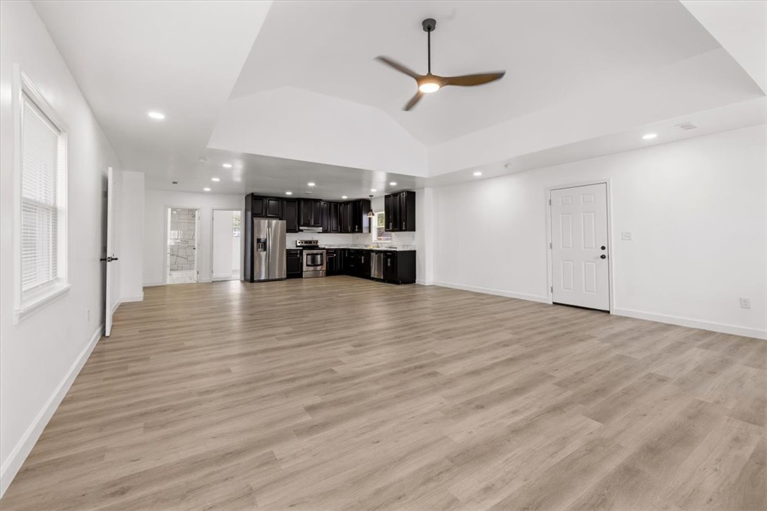 629 Little Meadow Drive Riverside, OH 45404 - Photo 13 of 48 This expansive open-concept room features vaulted ceilings, ample lighting, and a modern kitchen.