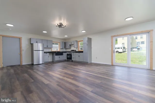 a view of a kitchen with a stove cabinets and wooden floor