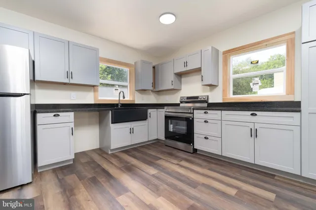 a kitchen with granite countertop white cabinets and white appliances