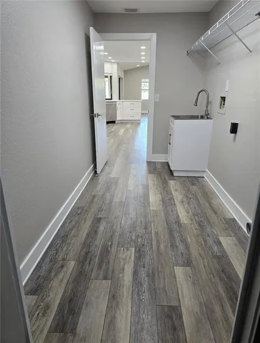 a spacious bedroom with a bed and glass door