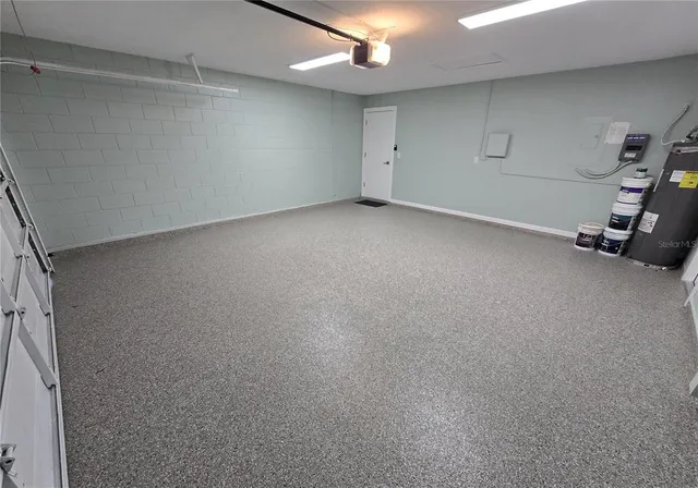 a large kitchen with a refrigerator a stove top oven a counter space and wooden floor