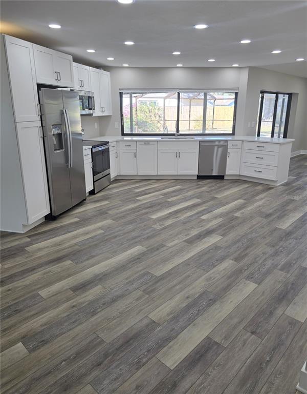 2940 Cypress Ridge Palm Harbor, FL 34684 - Photo 21 of 53 a large kitchen with a refrigerator a stove top oven a counter space and wooden floor