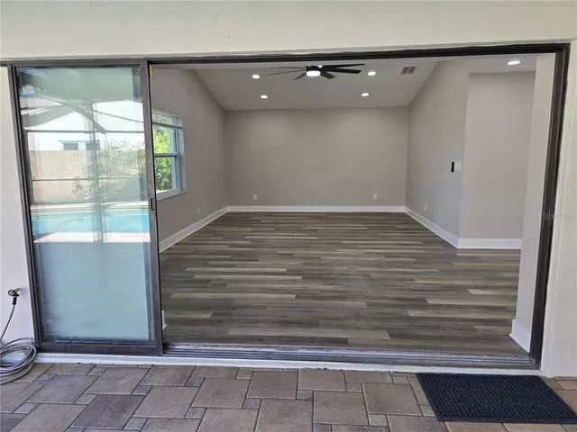 a view of hallway with wooden floor and a fireplace