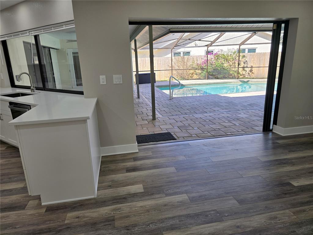 2940 Cypress Ridge Palm Harbor, FL 34684 - Photo 32 of 53 a view of hallway with wooden floor and a fireplace