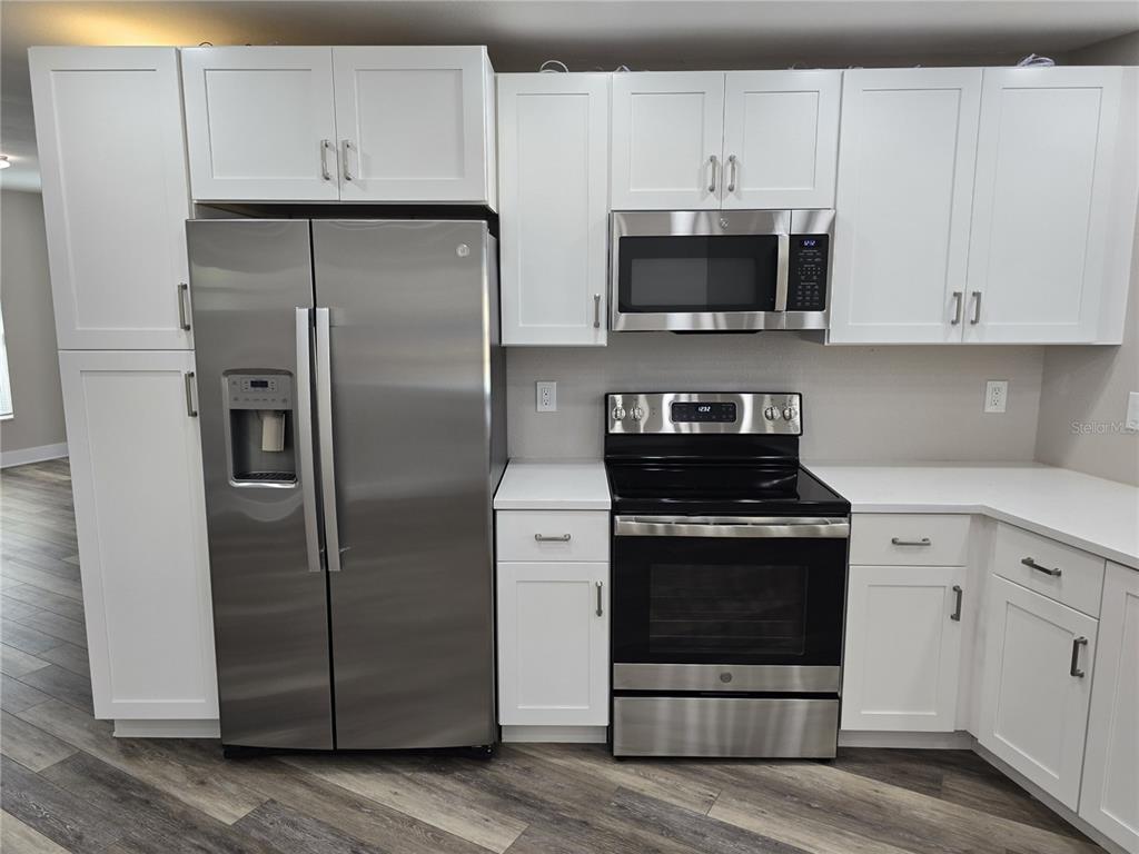 2940 Cypress Ridge Palm Harbor, FL 34684 - Photo 35 of 53 a kitchen with stainless steel appliances a stove a microwave and a refrigerator