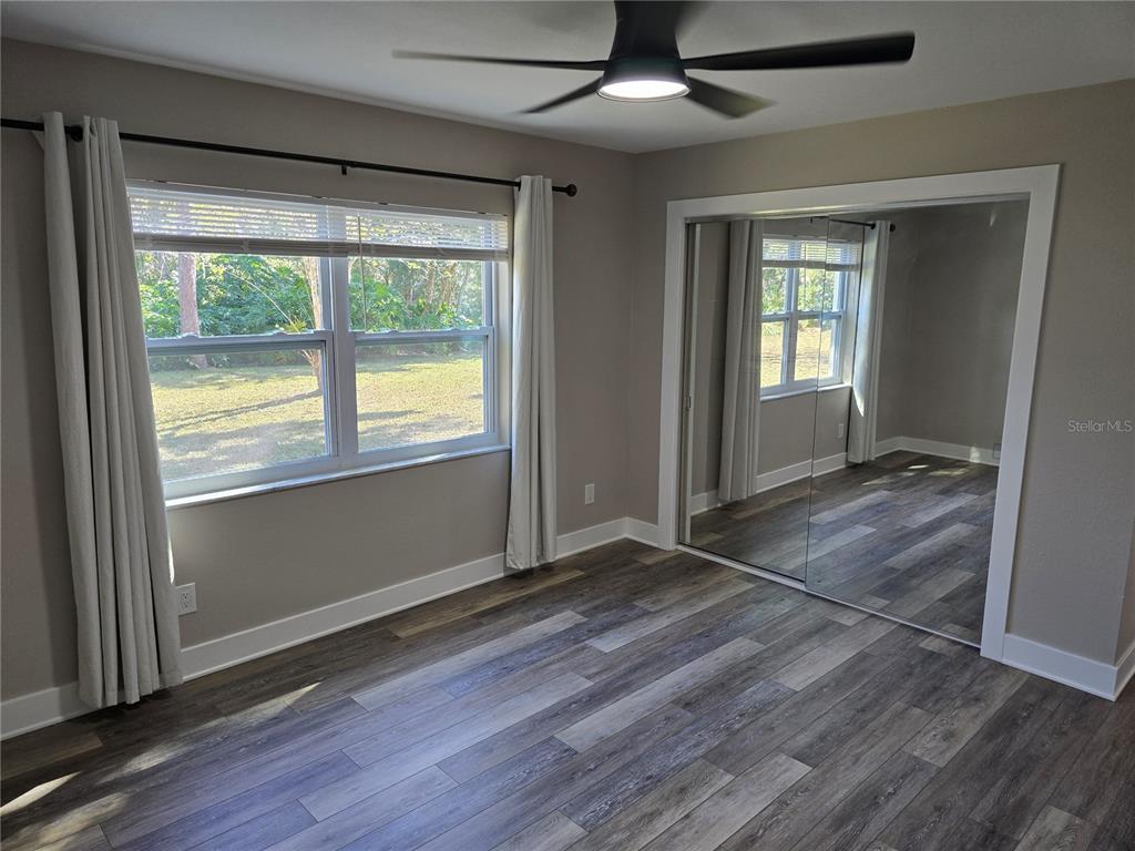 2940 Cypress Ridge Palm Harbor, FL 34684 - Photo 40 of 53 an empty room with wooden floor and windows