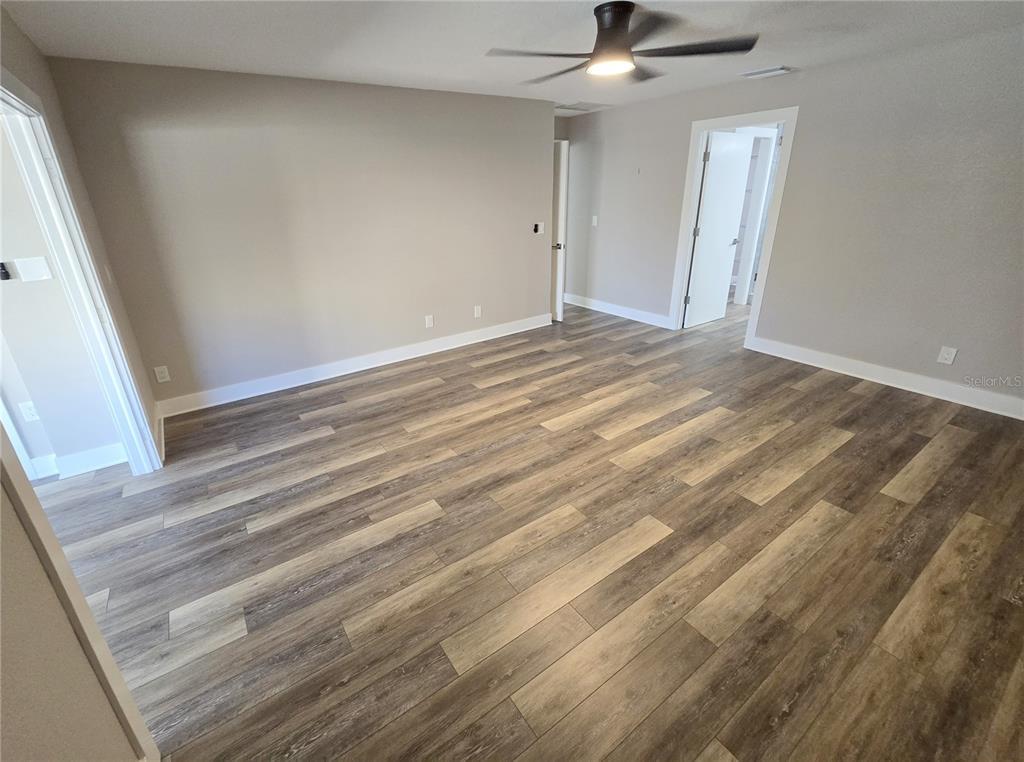 2940 Cypress Ridge Palm Harbor, FL 34684 - Photo 49 of 53 en empty room with wooden floor fan and window