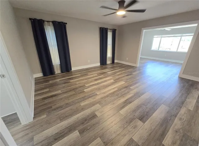 a view of a room with wooden floor