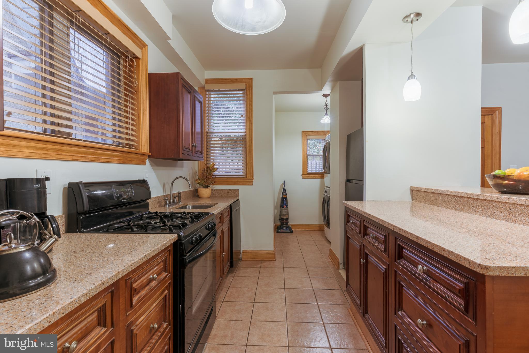 3817 22nd Street Northeast Washington, DC 20018 - Photo 11 of 37 a kitchen with a sink stove and cabinets