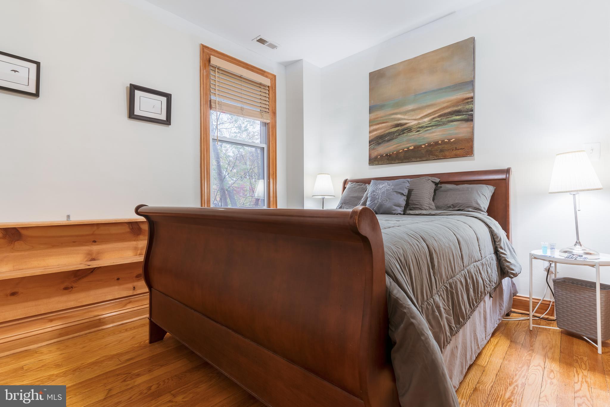 3817 22nd Street Northeast Washington, DC 20018 - Photo 19 of 37 a bedroom with a bed and wooden floor