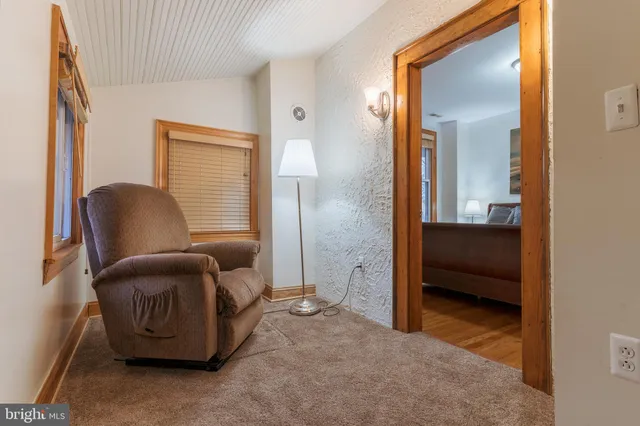 a living room with furniture and a chair