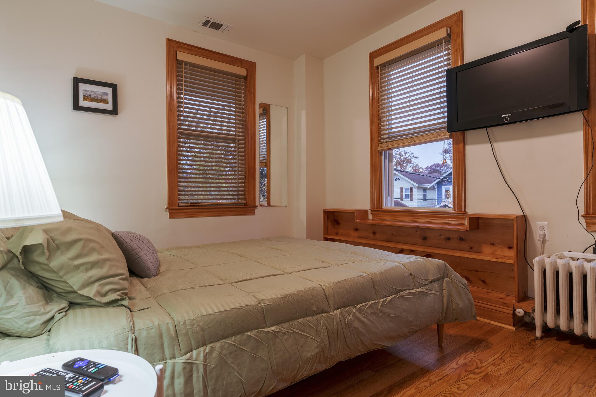 3817 22nd Street Northeast Washington, DC 20018 - Photo 22 of 37 a bedroom with a bed and flat screen tv