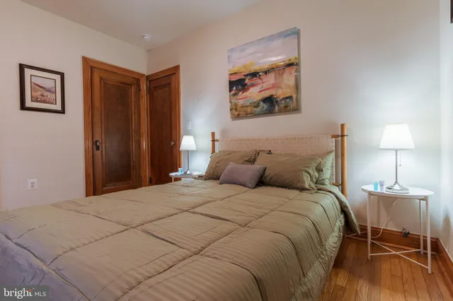 a bedroom with a bed and a lamp on table