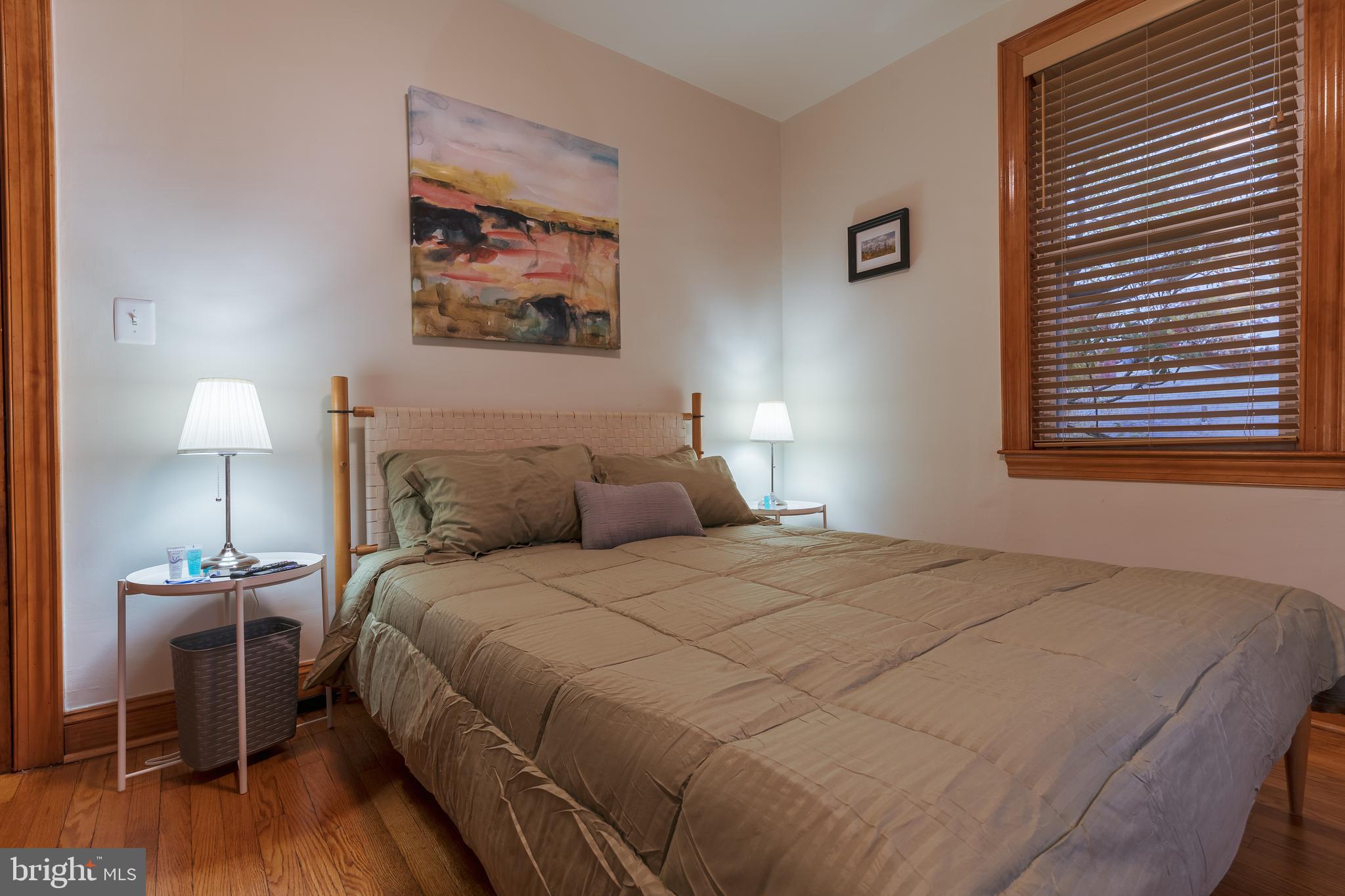 3817 22nd Street Northeast Washington, DC 20018 - Photo 24 of 37 a bedroom with a bed and a lamp